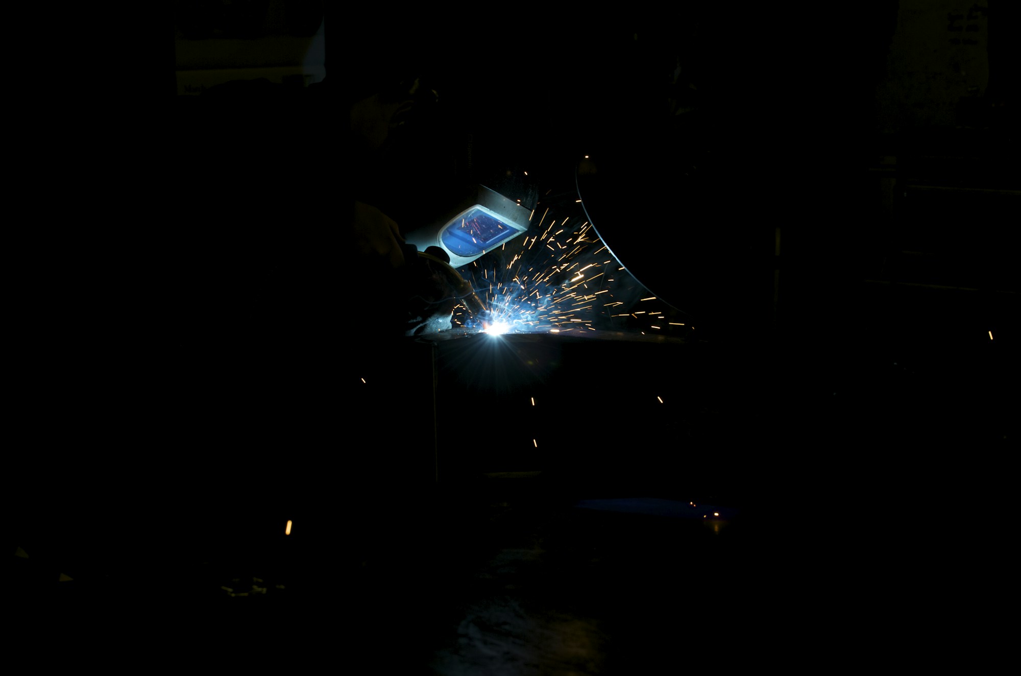Welding metal components in a workshop — process photograph