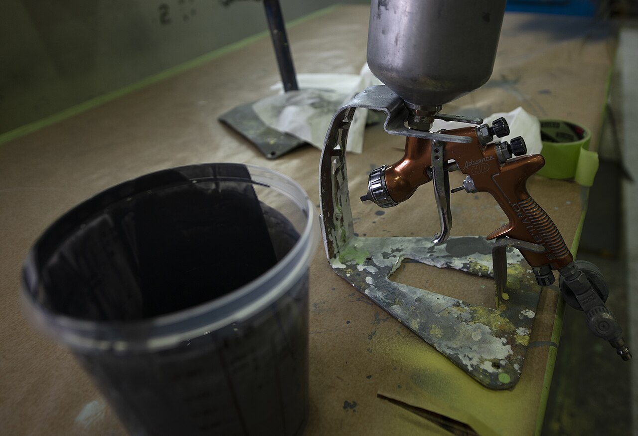 Spray gun and painting materials — process photograph